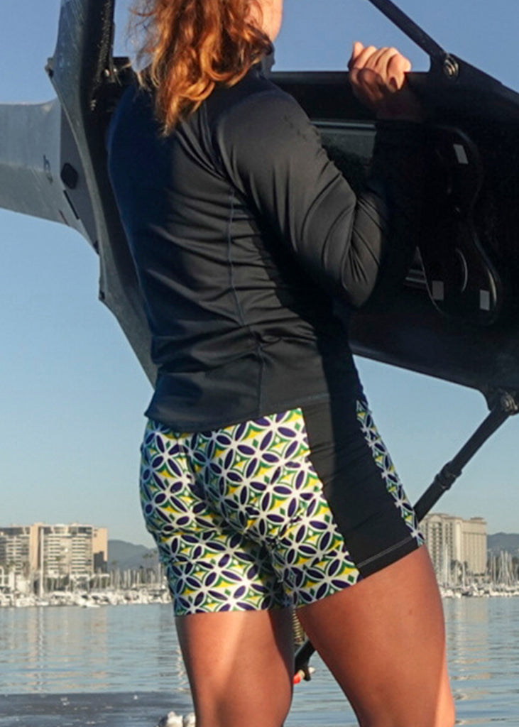 Person wearing a JL Women's Mosaic Banded Trou lifting up a boat near the water