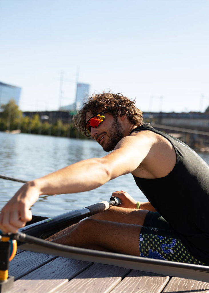 tiger rowing shorts on water in shell adjusting oar lock